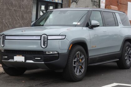 Rivian R1S electric SUV parked on a city street with New York license plate