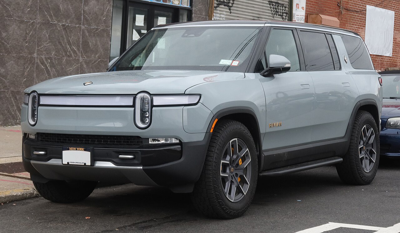 Rivian R1S electric SUV parked on a city street with New York license plate